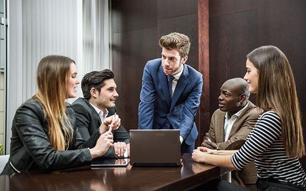 Businesspeople, teamwork. Group of multiethnic busy people working in an office