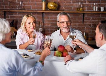 63077010 - calm and happy. middle-aged couple listening for toasting at table
