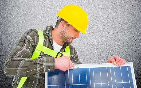 Digital composite image of man fixing solar panel