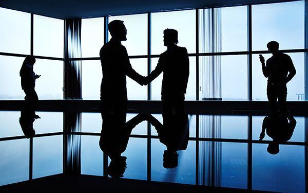 Silhouettes of business people in office
