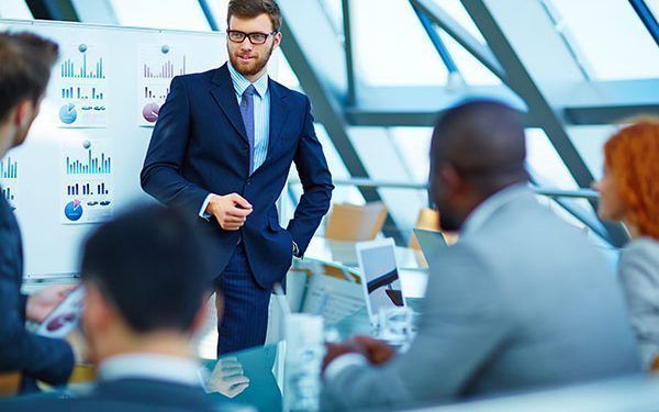 Young businessman making presentation to his colleagues