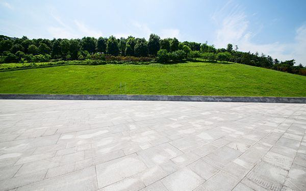long empty footpath in modern city square with skyline