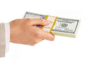 Image of female hand holding dollar bill on a white background