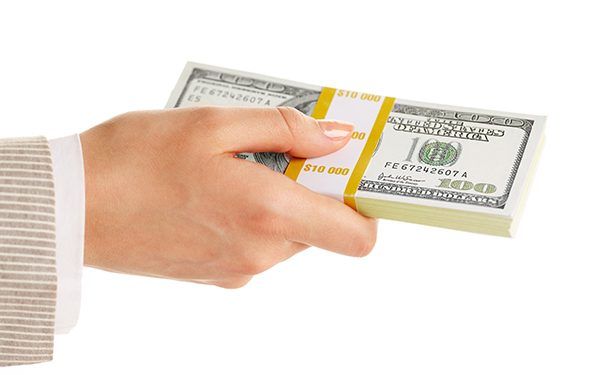 Image of female hand holding dollar bill on a white background