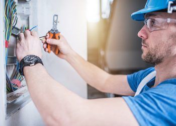 Electric Technician Job. Caucasian Professional Electrician in His 30s Finishing Electric Box Inside the Apartment.