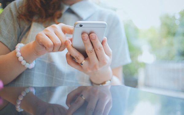 Woman using smartphone or mobile phone in the cafe