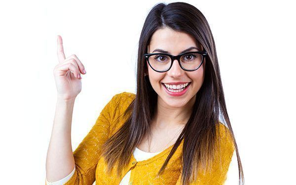 Portrait of pretty young woman with casual wear pointing up