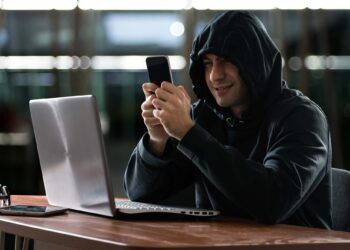 Hacker using a smartphone