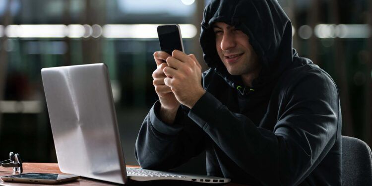 Hacker using a smartphone