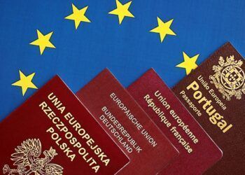 European union countries passports on blue EU flag close up. Portugal, German, French and Polish passports