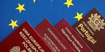 European union countries passports on blue EU flag close up. Portugal, German, French and Polish passports