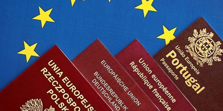 European union countries passports on blue EU flag close up. Portugal, German, French and Polish passports