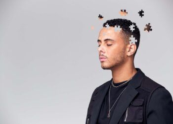 Mental Health Concept Of Young Man With Jigsaw Shaped Pieces Missing From Mind