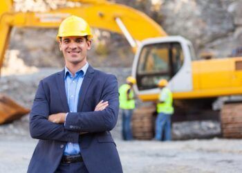 cheerful manager with arms crossed