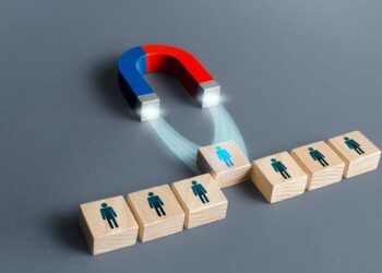Magnet pulls a person out of row blocks. Choosing best candidate for hiring. Competition for a working high position of a manager. Poaching participants from other company team. Luring concept
