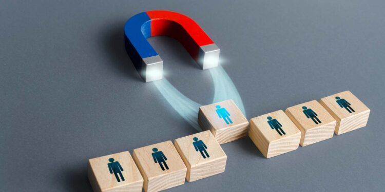 Magnet pulls a person out of row blocks. Choosing best candidate for hiring. Competition for a working high position of a manager. Poaching participants from other company team. Luring concept