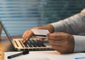 Businessman doing online banking, he is making e-payments with a credit card and his laptop, online business and finance concept