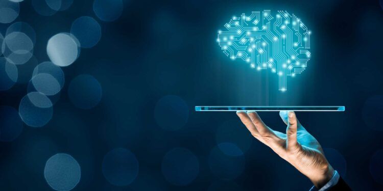 Artificial intelligence (AI), machine deep learning, data mining, and another modern computer technologies concepts. Brain representing artificial intelligence and businessman holding futuristic tablet.