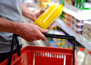 man buys food, row of shelves with groceries in a supermarket, marketing concept, prices for consumer goods, consumer basket