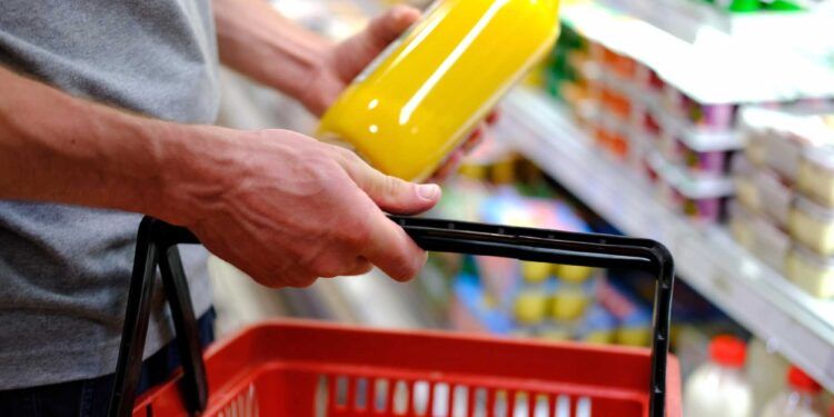 man buys food, row of shelves with groceries in a supermarket, marketing concept, prices for consumer goods, consumer basket