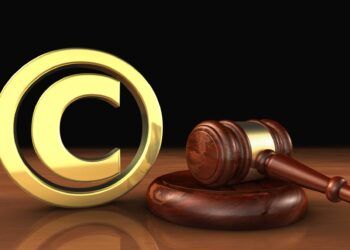 Copyright intellectual property and digital copyright laws conceptual illustration with symbol and icon and a gavel on black background.