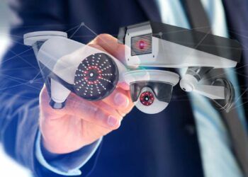 View of a Businessman holding a Security camera system and network connection - 3d rendering